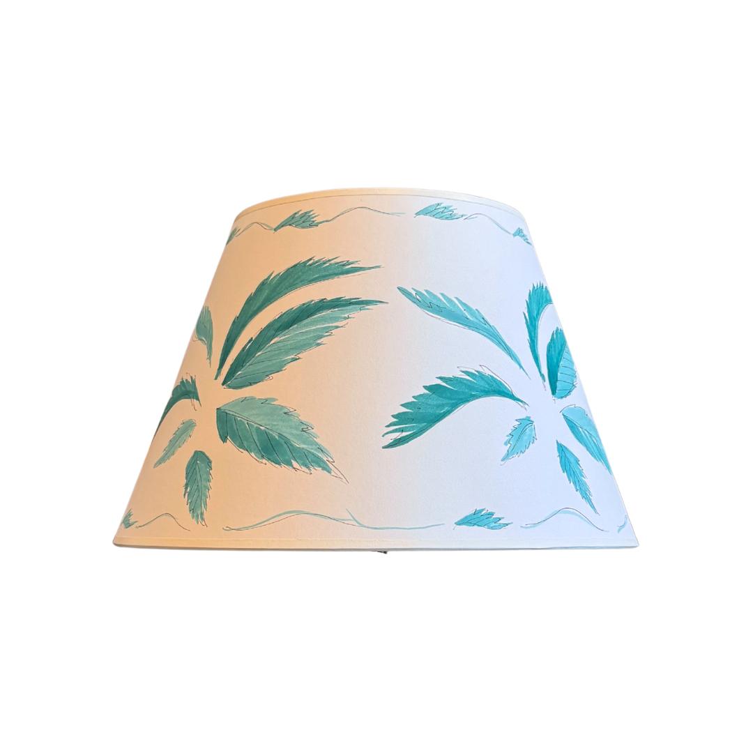 Lampshade with palm leaf pattern on a white background