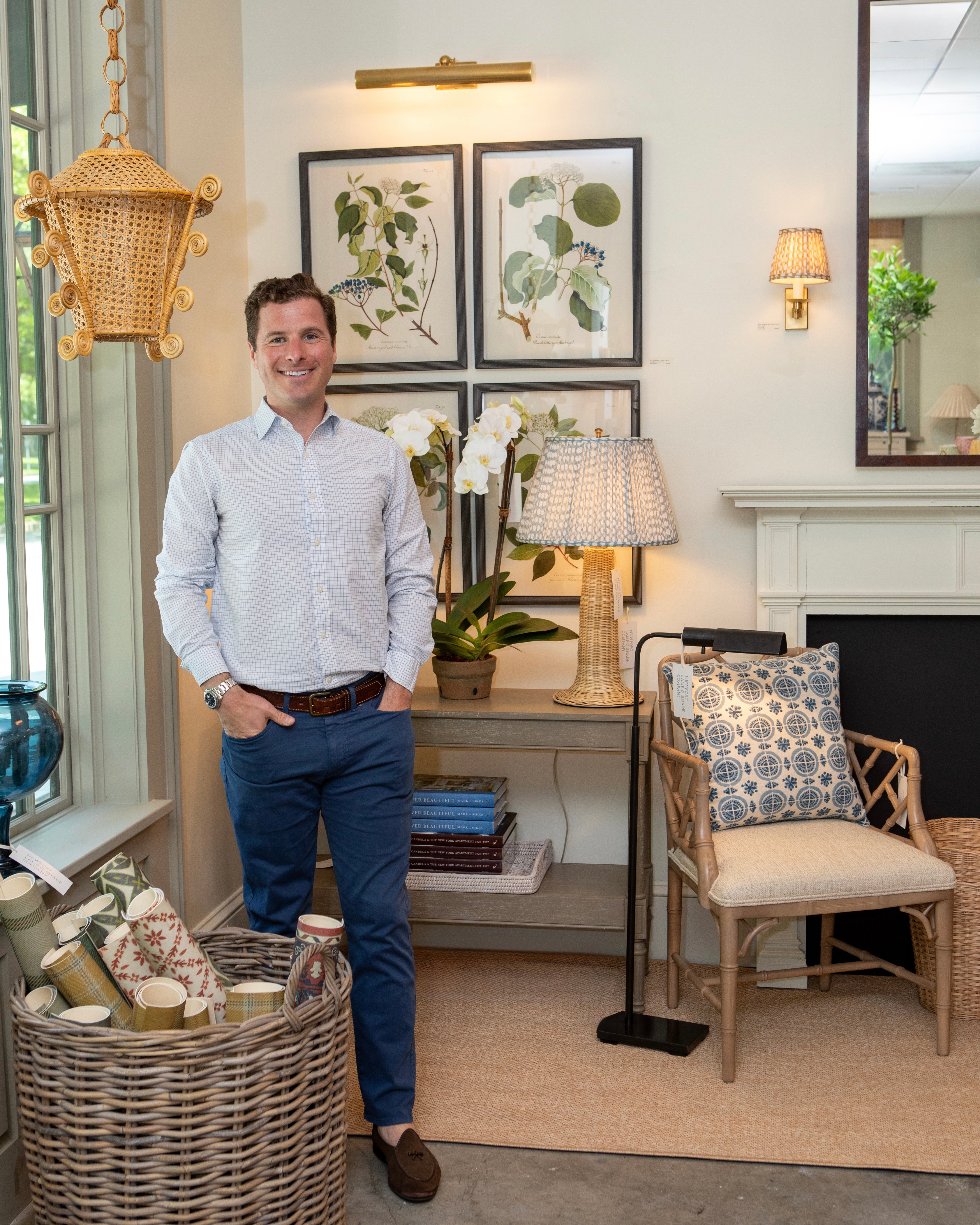 Man standing in a stylish living room with decor elements.