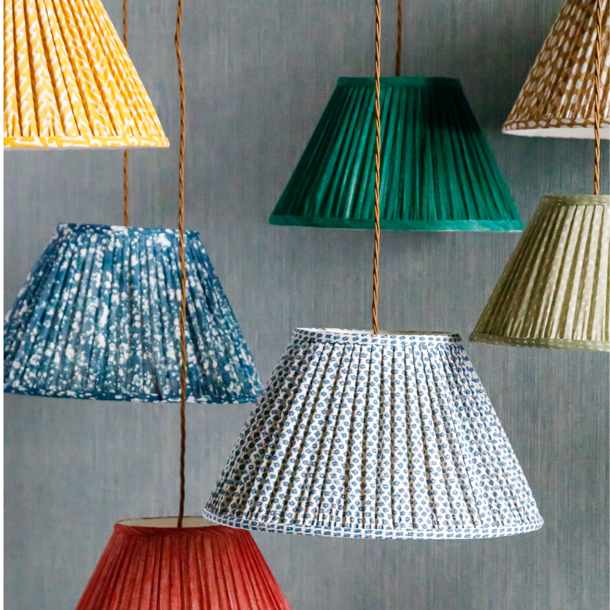 a group of colorful lampshades hanging