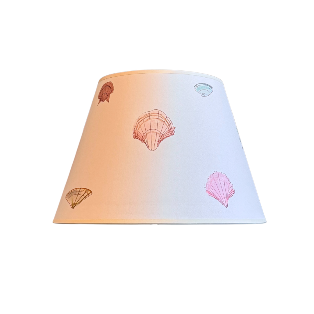 Gradient lampshade with shell designs on a white background
