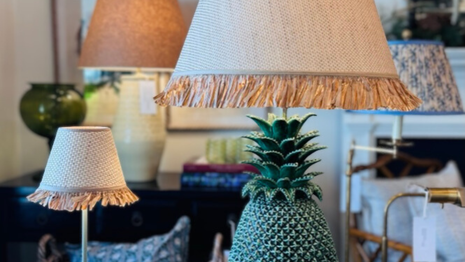 Decorative pineapple with lampshades on a wooden table in a home setting